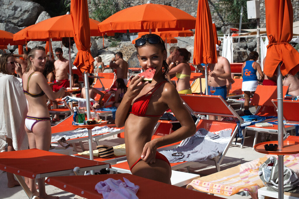 Rachel eating watermelon at One Fire Beach Club wearing Sommer Swim on the Amalfi Coast.